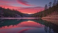 Crimson sunset reflects on tranquil lake framed by pine-covered ridgelines Royalty Free Stock Photo