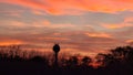 Crimson sunset in ridgeway wi with the water tower against the horizon