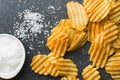 Crinkle cut potato chips with salt. Royalty Free Stock Photo