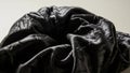 Crinkled black fabric on plain background Royalty Free Stock Photo
