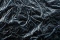 Crinkled black plastic texture with highlights and shadows