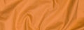 Crinkled orange textile material with visible texture Royalty Free Stock Photo