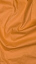 Crinkled orange textile material with visible texture Royalty Free Stock Photo