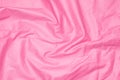 Crinkled pink material texture or background