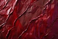 A crinkled satin fabric texture background in deep ruby red. The glossy, textured surface adds depth