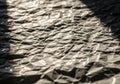 Crinkled silver foil with a reflective surface catches light, creating highlights and shadows. The Royalty Free Stock Photo