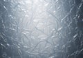 Crinkled silver foil sheet with a textured, reflective surface. Light glimmers off the Royalty Free Stock Photo