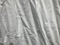 Crinkled white linen fabric in full frame shot