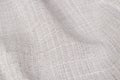 Crinkled woven textile. Grid pattern. Distinctive background in creamy color