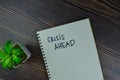 Crisis Ahead write on a book isolated on Wooden Table Royalty Free Stock Photo