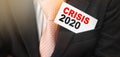 Crisis 2020 on a card in businessman pocket. Economical financial crisis concept Royalty Free Stock Photo