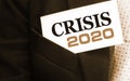 Crisis 2020 on a card in businessman pocket. Economical financial crisis concept Royalty Free Stock Photo