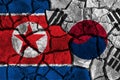 Crisis and confliction concept of South korea and North korea . flags on cracked ground background