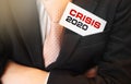 Crisis 2020 words on a card in businessman upper suit pocket. Economical financial crisis concept Royalty Free Stock Photo