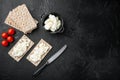 Crisp breads with butter, on black dark stone table background, top view flat lay, with copy space for text Royalty Free Stock Photo