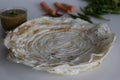 Crisp carrot onion dosa served with a bowl of sambar Royalty Free Stock Photo