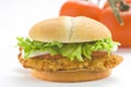 Crisp chicken burger tomato onion cheese lettuce Royalty Free Stock Photo