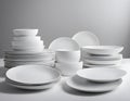 A crisp and clean image featuring a harmonious stack of pristine white plates, meticulously Royalty Free Stock Photo