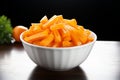 Crisp and fresh Frozen orange carrot in white bowl, healthy