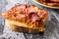 Crisp fried bacon on the bread above grey granite background