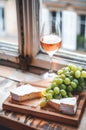 A crisp glass of rose wine sits on a windowsill Royalty Free Stock Photo