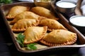 crisp golden empanadas on a paper lined tray