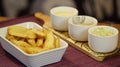 Crisp rustic fries served on a tray with three sauce bowls