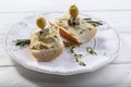 Crisp rye toasts with cream avocado, cheese and olives on plate