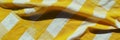 Crisp texture of yellow gingham tablecloth evokes warmth and charm in any setting Royalty Free Stock Photo