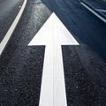 Guiding Arrow on a Dark Asphalt Road Royalty Free Stock Photo