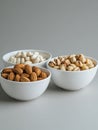 Crisp White Ceramic Bowls of Nuts and Creamy Almonds Royalty Free Stock Photo