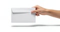 a crisp white envelope is being held by a human hand casting a subtle shadow on a blank surface Royalty Free Stock Photo