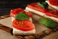 Crispbread with feta cheese, red tomatoes and mini spinach leaves