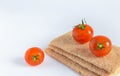 Crispbread and tomatoes on a light background with copy space.