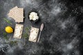 Crispbreads with feta, on black dark stone table background, top view flat lay, with copy space for text Royalty Free Stock Photo