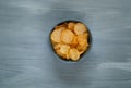 Crisps in a blue bowl on a light blue background, space for text.Convenient snack concept