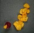 Crisps with ketchup on a light blue background, top view, space for text.