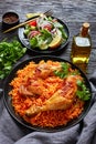 Crispy baked chicken leg quarters over tomato rice