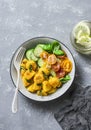 Crispy baked slices of polenta with sage butter and vegetables cucumbers, tomatoes, basil salad on a gray background, top view. Royalty Free Stock Photo