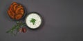 Crispy baked sweet potato chips with yogurt garlic chive dip sauce in black bowls Royalty Free Stock Photo