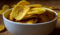 Crispy banana chips in a bowl. Common Indian savory item