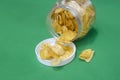 Crispy banana chips on green background Royalty Free Stock Photo