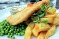 Traditional english food fish and chips with green peas