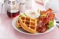 Crispy Belgian waffles with avocado and bacon for breakfast