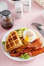 Crispy Belgian waffles with avocado and bacon for breakfast