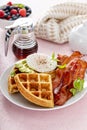 Crispy Belgian waffles with avocado and bacon for breakfast