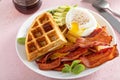 Crispy Belgian waffles with avocado and bacon for breakfast