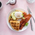 Crispy Belgian waffles with avocado and bacon for breakfast