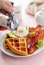 Crispy Belgian waffles with avocado and bacon for breakfast