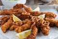 Breaded chicken breast with pretzel breading on a baking tray